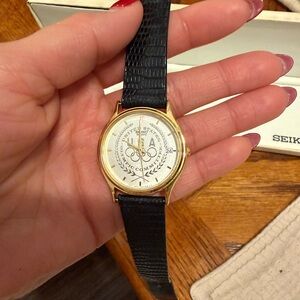 Seiko Gold Tone Watch with Black Leather Strap and Olympic Dial